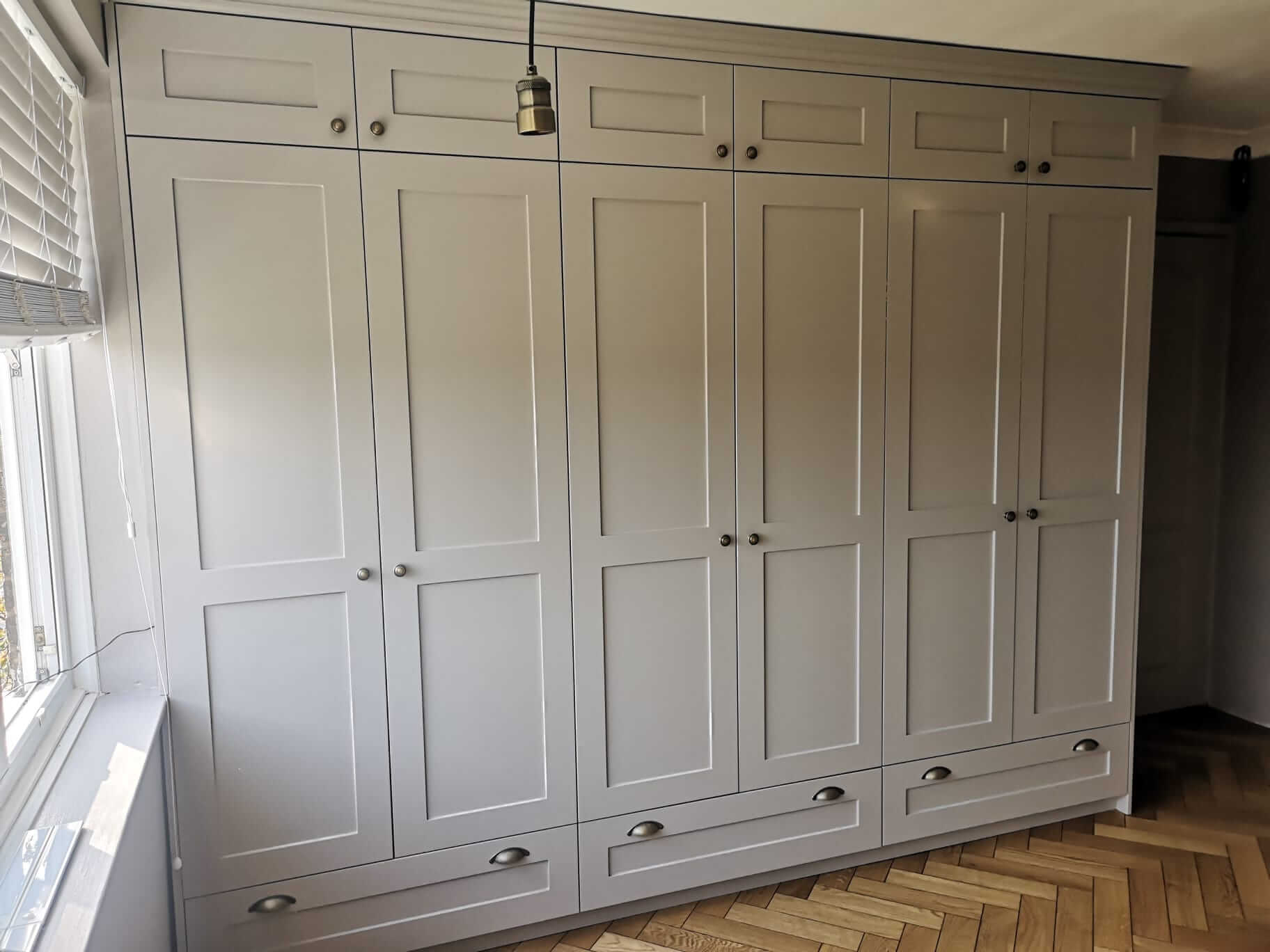 Fitted Wardrobes in Shaker style with storage above and below