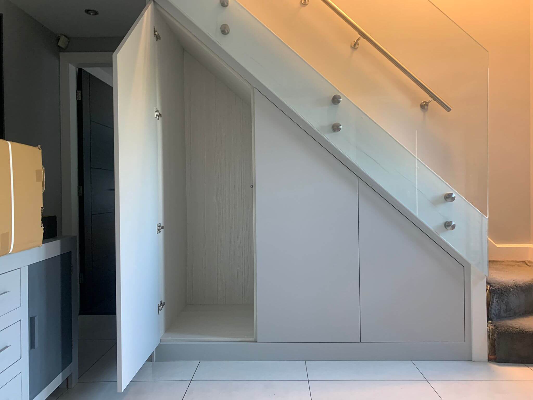 Under Stairs Storage with shoe and bag racks and cloak room.